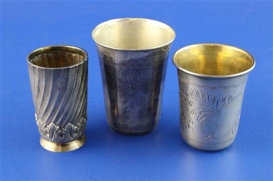 Three silver tumblers.